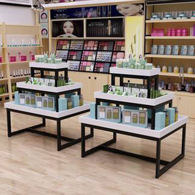 Mesa da promoção da Três-história do supermercado materna e cosméticos da loja da criança que empilham o armário de exposição